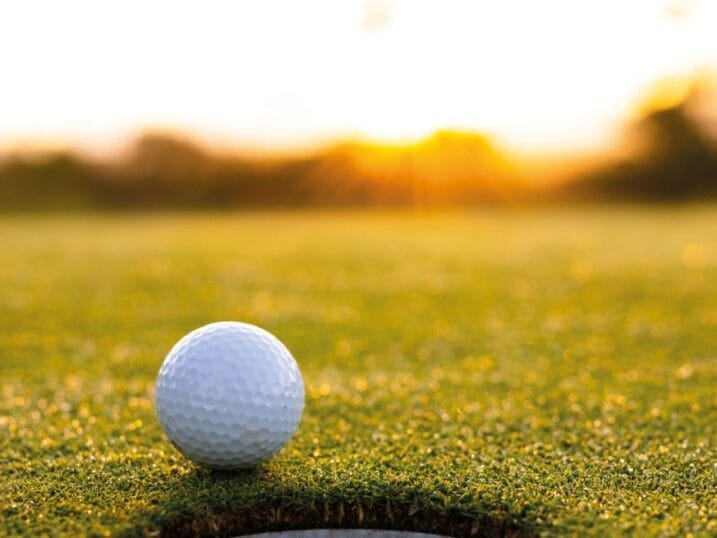 Golf ball on the edge of the hole