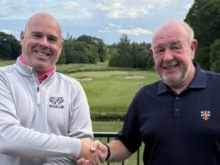 John Harrison receiving the winner's cheque