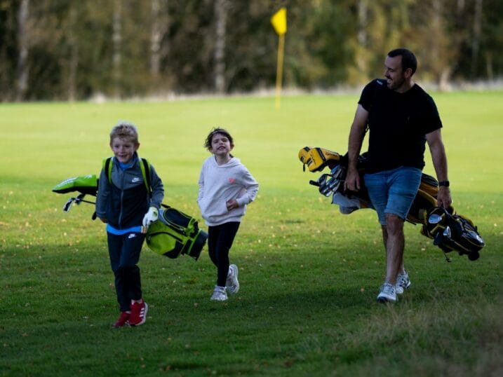 Family of golfers walking together
