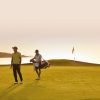 Caddy and player on green