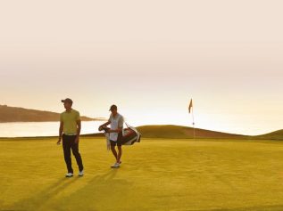 Caddy and player on green