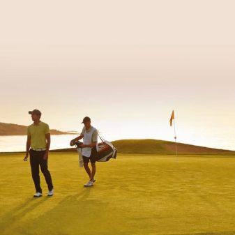Caddy and player on green