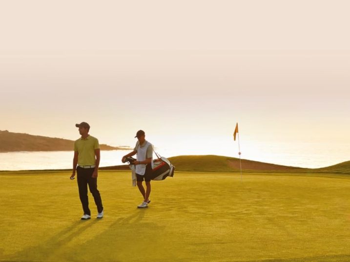 Caddy and player on green