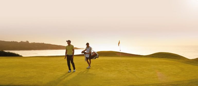 Caddy and player on green