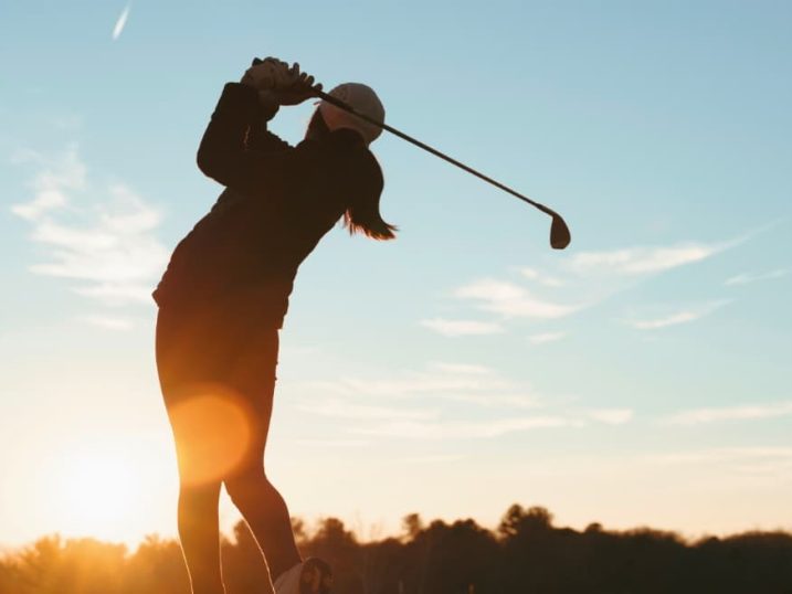 Junior golfer at sunset