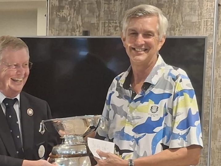 Gary Catt (right) receiving the trophy from YUGC president Bruce Light